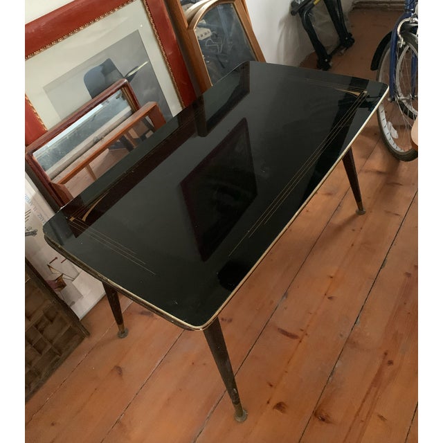 Very nice coffee table with glass shelf in great original condition.