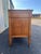 A vintage fruitwood triple dresser in a neoclassical style. Light coloring and complex burlwood grain patterns on the...