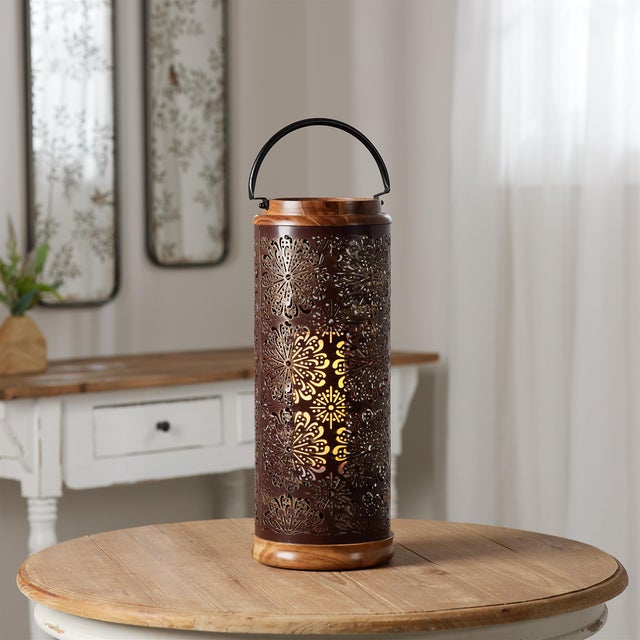 Elevate your home decor with the Punched Metal Lantern with Natural Wood Accents. Featuring a round, intricately punched...