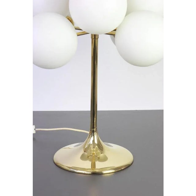Atomic brass table lamp with nine-glass globes. The globes are hand blown and fitted with a screwing device. High quality...