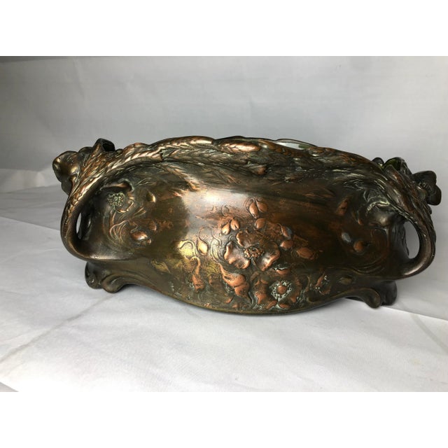 This Fives de Lille copper planter has a cracked dark green faience interior. This piece is attributed to the mentioned...