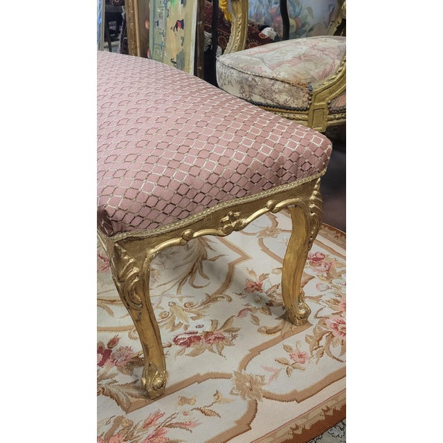 Beautiful French style uphostered carved bench. Features new fine pale shimmery mauve upholstery and a carved gilt wood...
