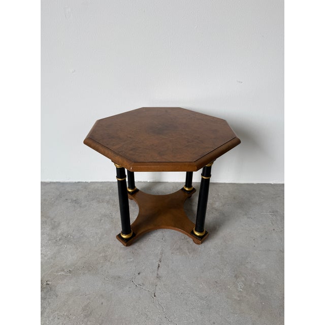 Elegant vintage Regency-style side table by Baker Furniture, featuring a beautifully figured octagonal burlwood veneer top...