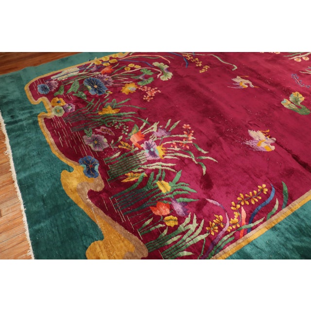 Enchanting Large room size 20th-century Chinese Art Deco carpet with a spacious floral design on a Burgundy Field...