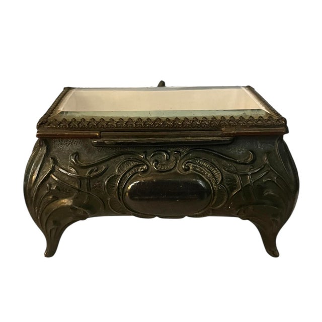 Decorative Victorian or Art Nouveau metal trinket box or jewelry casket with hinged lid. Scrolling floral and leaf design...