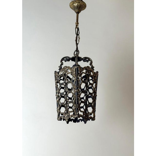 Decorative European hanging lantern dating from the 1960s or 1970s, crafted from solid cast brass with a beautifully aged,...