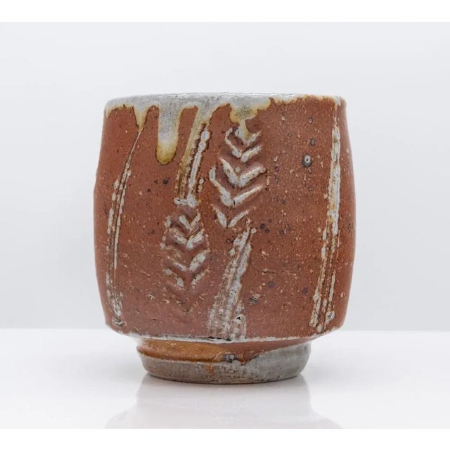 Two Phil Rogers (1951 - 2020) Yunomi. Artist's impressed stamp marks 'PR'. One wood fired Yunomi with wax resist impressed...