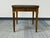 This is a vintage French Louis XVI-style accent table by Baker Furniture, featuring book-matched walnut grain veneers and...