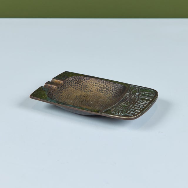 Mid-century brass Pal-Bell ashtray features a rectangular shape with a deep square hammered well and two cigarette...