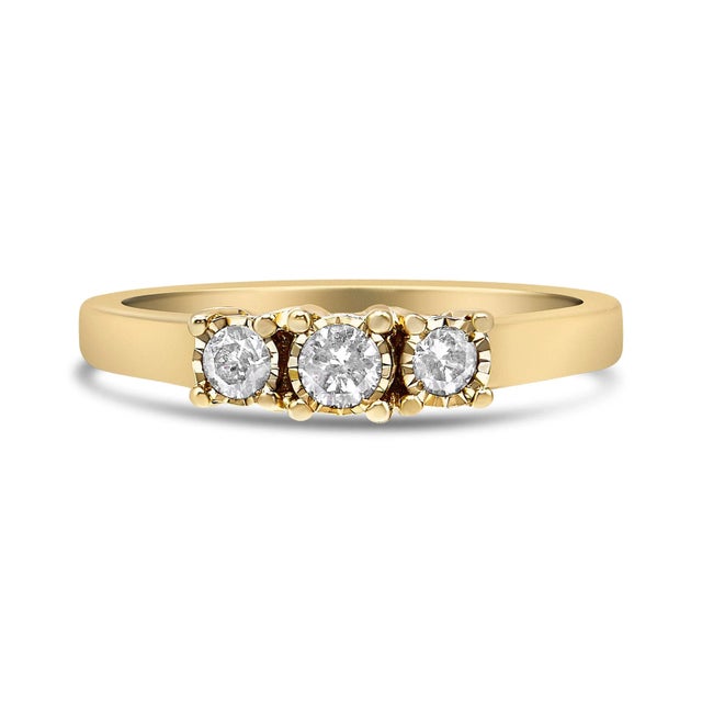 Elegant and timeless, this gorgeous 3 stone ring is created in shining .925 sterling silver plated with 14k yellow gold....