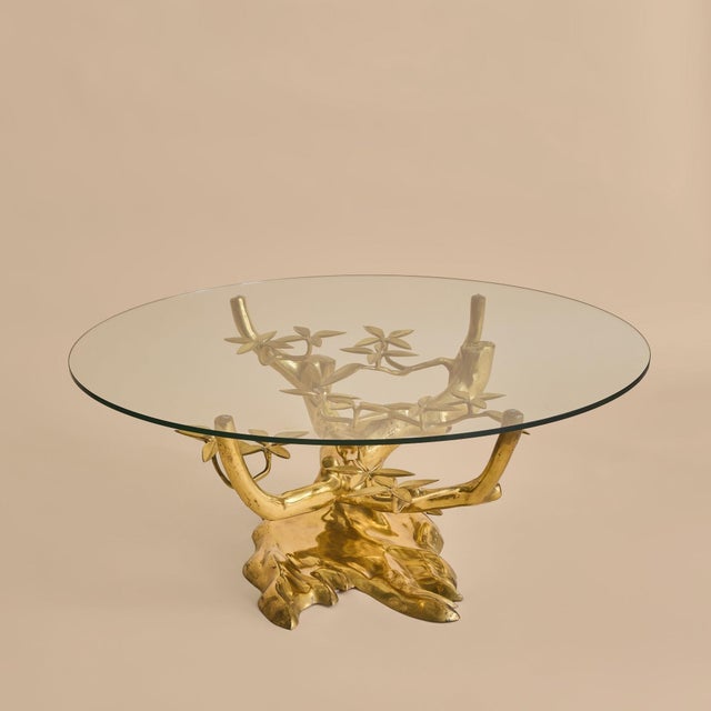 A 1970s Belgian coffee table by Willy Daro, defined by its sculptural brass base shaped like a bonsai tree. A round glass...