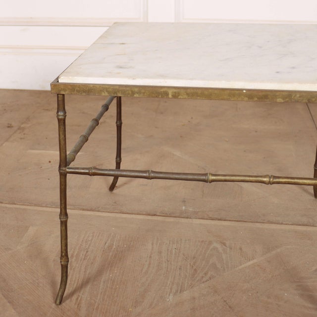 Early 20th century French faux bamboo brass lamp table with a marble top. 1920. This piece is designed in the style of the...