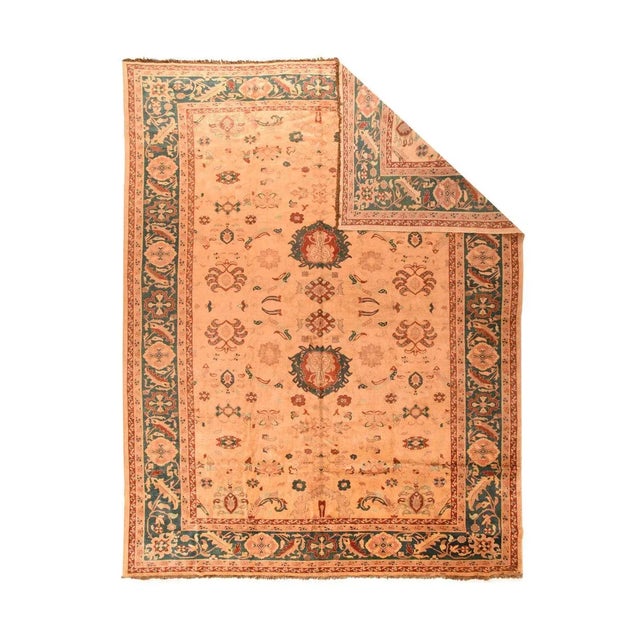 The cream field shows two addorsed red and blue-green ragged palmettes along the centre line, flanked by "spider"...