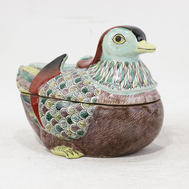 This exquisite vintage Chinese porcelain covered bowl is masterfully sculpted into the form of a seated Mandarin duck, a...
