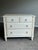 Elegant Swedish Neoclassical inspired chest by Ethan Allen featuring a soft distressed ivory painted finish with subtle...