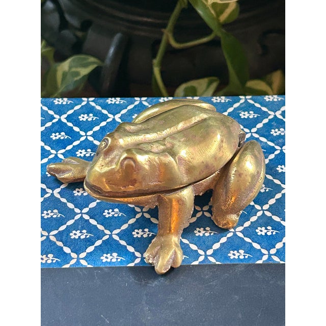 This is a vintage cast brass box modeled as a wonderfully detailed frog. The frog’s back forms a hinged lid, opening to...