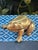 This is a vintage cast brass box modeled as a wonderfully detailed frog. The frog’s back forms a hinged lid, opening to...