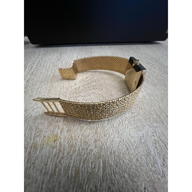 Vintage 14 K Gold Tiffany & Co. timepiece featuring a classic square case and a distinctive gold mesh bracelet. High...