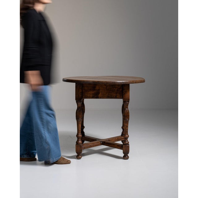 This 1970s Neo-Renaissance oak table in original patina from France is made in dark oak with a single drawer, turned legs...
