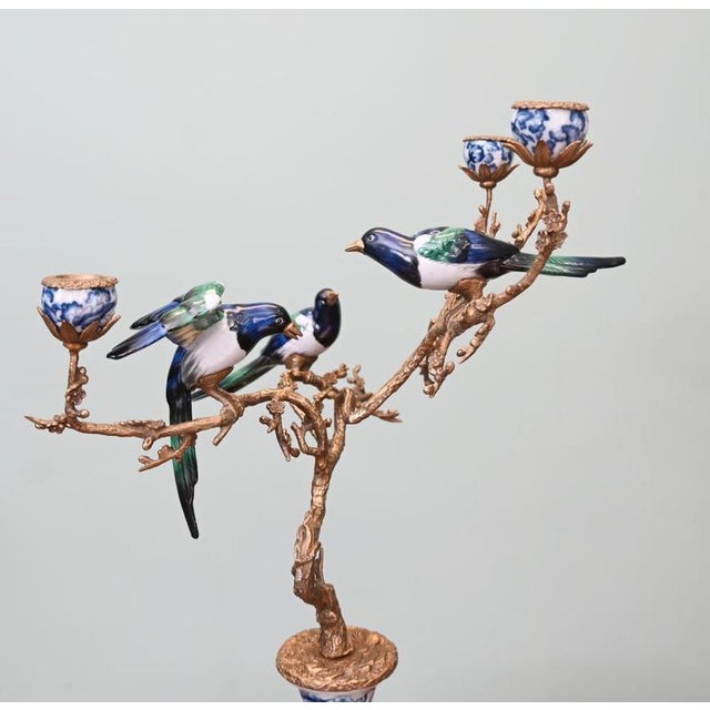 Very eye catching single porcelain and gilt candelabra adorned with birds Blue and white base holds aloft the ormolu...
