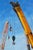 This oil painting presents a dynamic scene of cranes against a bright blue sky, capturing the industrial landscape with a...
