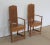 Pair of trapezoidal trapezoidal armchairs in blond oak. Its narrow folder has an interior design panel with scrolls...