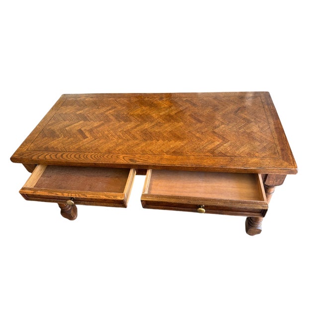A beautifully crafted solid oak writing desk featuring an eye-catching parquetry top and traditional turned legs. The...