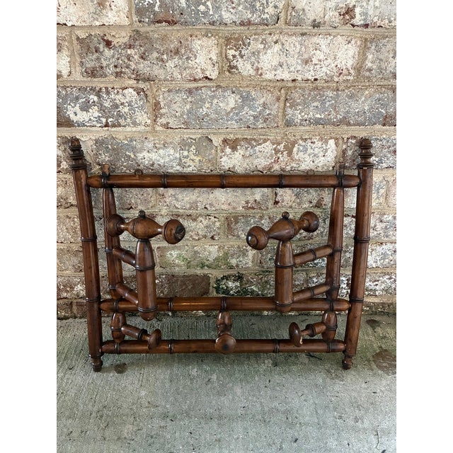 Faux bamboo wall mounted coat rack, Late 19th Century, France. This French antique wall hung coat rack features "folding"...
