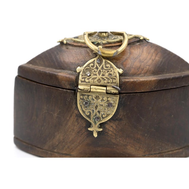 A very unusual lozenge shaped hardwood box (possibly tea caddy or tobacco box) with decorative solid brass mountings. Made...