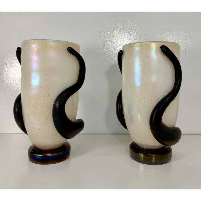 Elegant pair of sculptural Murano glass vases, crafted in Italy and signed Cenedese Murano underneath the bases. Each vase...