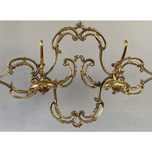Wow, move over Rococo! Solid cast brass (the four hat and coat holders are each held on by two screws). Just...
