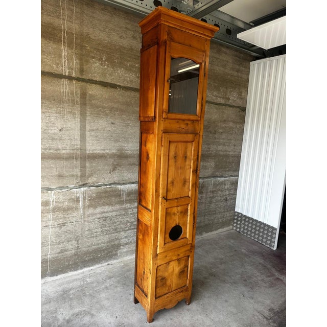 Large French grandfather clock case in solid cherry wood, dating from the early 19th century. with its elegant, slender...