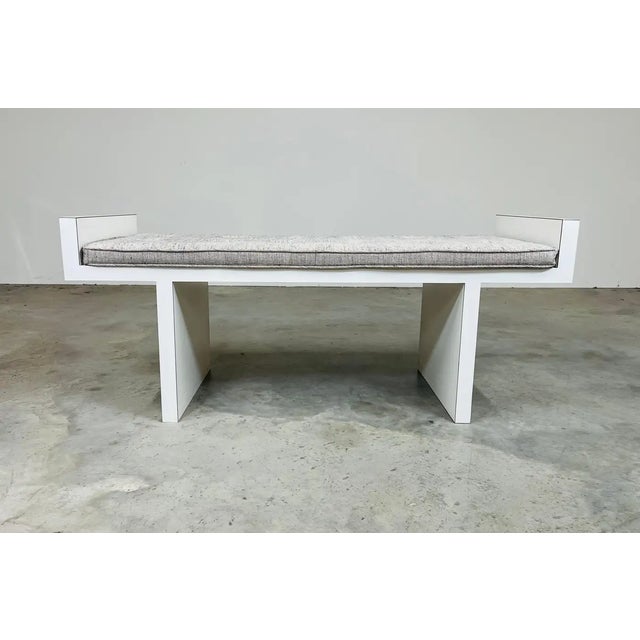An attractive mid-century modern minimalist entryway or window bench having white laminate frame over solid wood with...