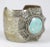 This is part of Chairish’s Costume Jewelry assortment. Wide silvertone cuff with large decorative enamel medallion with...