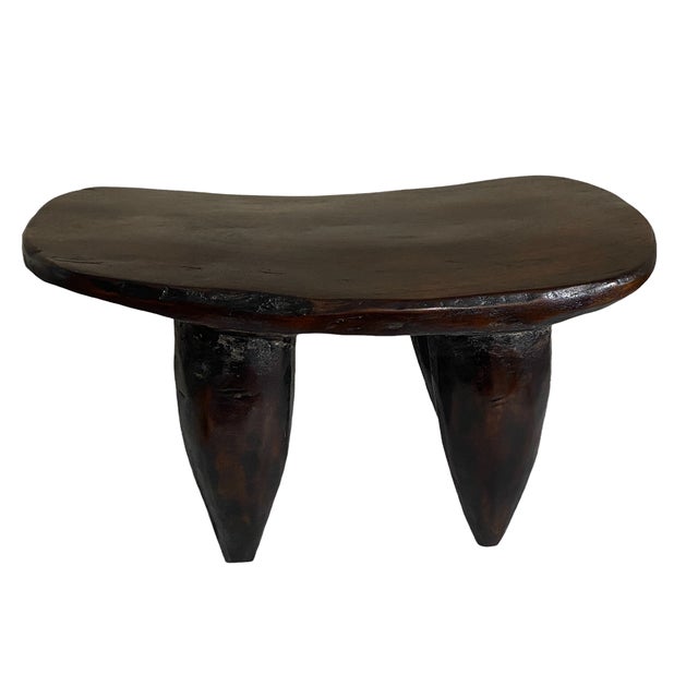 Superb vintage African Senufo milk stool on four tapered legs with an abstract form . sculpted from one piece of heavy...