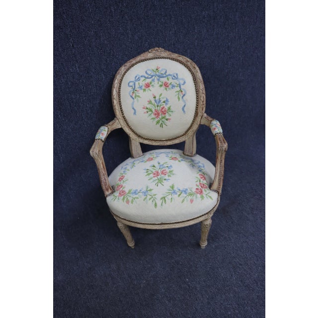 Late 19th Century open arm chair , hand chair frame with naturally distressed cream painted finish , floral needlepoint...