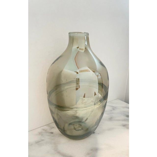 Mirrored reflective finish on a uniqe hand blown smoky glass vase. Dynamic light reflections add interest to otherwise...
