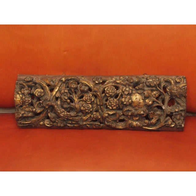 A highly carved decorative fragment of rinceau surrounding flowering plants, the scrolling chain incorporating birds, and...