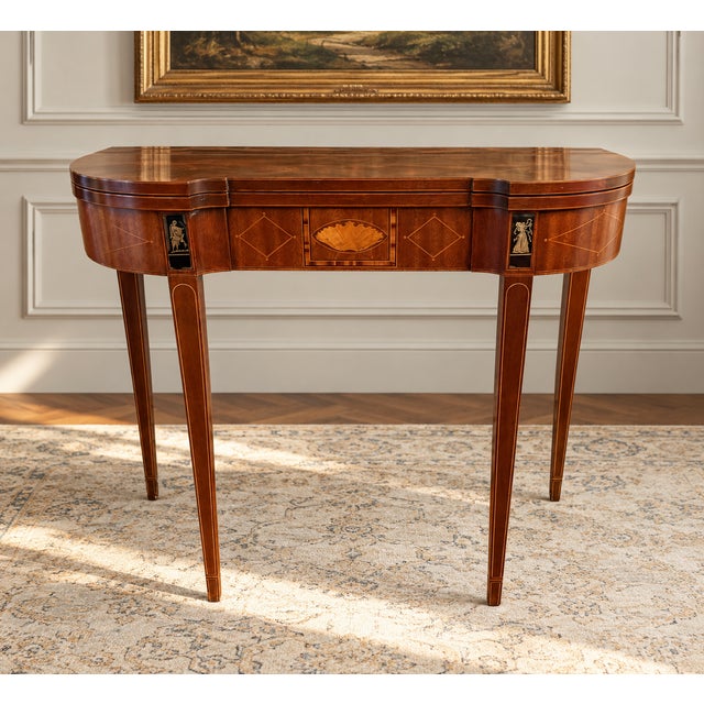 An elegant vintage mahogany folding game table by Baker Furniture, from the distinguished Historic Charleston...