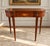 An elegant vintage mahogany folding game table by Baker Furniture, from the distinguished Historic Charleston...