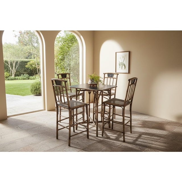 This striking pagoda-style Chinoiserie bamboo table and stool set is crafted from genuine bamboo, showcasing exceptional...