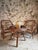 Vintage rattan lounge set dating from approximately 1930–1950, consisting of two lounge chairs and one matching round...