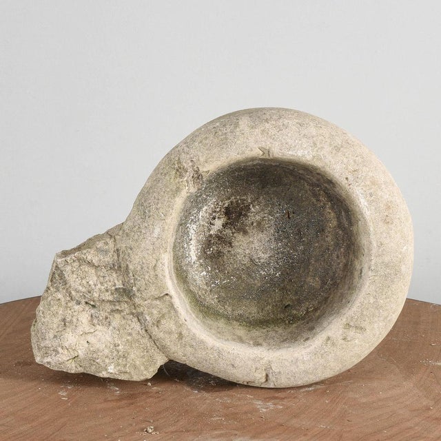 This sturdy stone bowl, designed to be fixed to the wall, is an element that combines rustic functionality and old-...