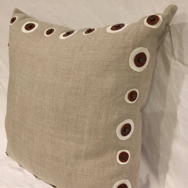 Natural linen toss pillow with dark brown leather circle detailing, feather insert included.