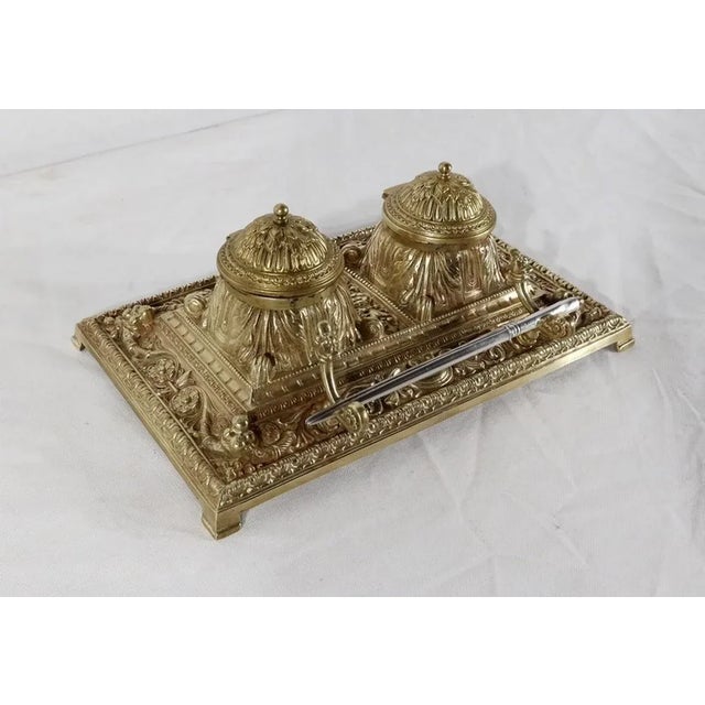 Magnificent inkwell in the Renaissance style in gilt bronze. On a rectangular base, two ink containers with dome-shaped...