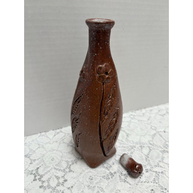 Vintage rustic handmade bottle, bud vase or vessel. Rugged hand carved flowers with a primitive simplistic design in a...