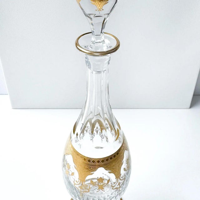 An extraordinary Baccarat Prestige crystal decanter, measuring an impressive 17 ¾ inches tall, and lavishly adorned in 24k...
