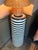 A bold sculptural pedestal by Wildwood featuring alternating bands of natural black and white stone inspired by the...
