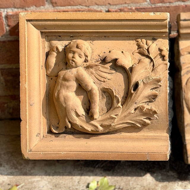 Antique late 19th century tri-parte tan terracotta facade plaque having a mythological cheurubic theme. Provenance:NYC...