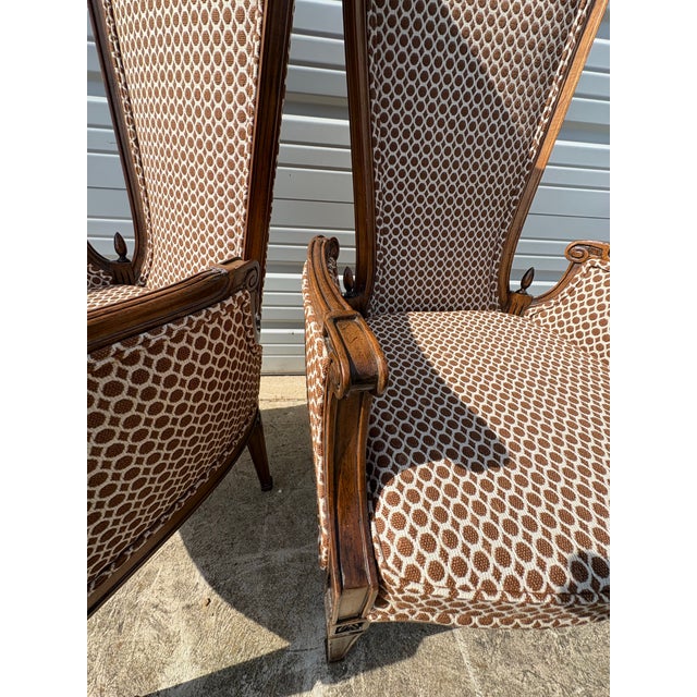 This is a pair of mid-century vintage stylized French country bergere chairs. This beautiful pair of French country chairs...